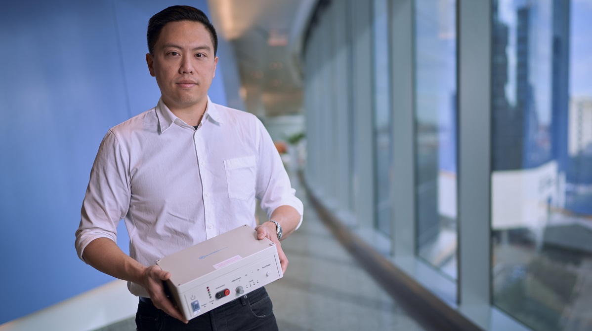 Albert Huang holds his StimSite device